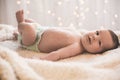 Happy newborn lying on blanket