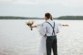 Happy newly married couple near lake, bride brunette young woman with boho bouquet, close up portrait outdoors Royalty Free Stock Photo