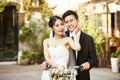 Asian newly wed couple riding a bicycle Royalty Free Stock Photo