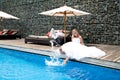 Happy newly wedding couple near pool