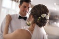 Happy newlywed couple dancing in festive hall