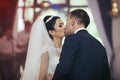 Happy newlywed couple dancing and kissing at wedding reception c Royalty Free Stock Photo