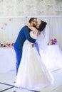 Happy newlywed couple kissing during their first dance at wedding reception Royalty Free Stock Photo