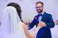 Happy newlywed couple smiling during their first dance at wedding reception