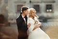 Happy newlywed groom hugging blonde beautiful bride from behind Royalty Free Stock Photo