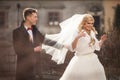 Happy newlywed groom hugging blonde beautiful bride from behind Royalty Free Stock Photo