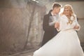 Happy newlywed groom hugging blonde beautiful bride from behind Royalty Free Stock Photo