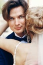 Happy newlywed groom hugging bride after wedding ceremony outdoors face close-up, newlywed couple portrait Royalty Free Stock Photo