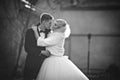 Happy newlywed groom hugging and kissing blonde beautiful bride Royalty Free Stock Photo