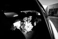 Happy newlyweds in the car b&w Royalty Free Stock Photo