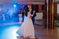 Happy newlyweds dance on the dance floor the first dance.