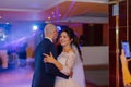 Happy newlyweds dance on the dance floor the first dance.