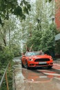 Happy newlyweds go to the celebration in a red car with an open top. Wedding Concept Royalty Free Stock Photo