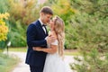 happy newlyweds. groom and bride in traditional wedding clothes kiss in park Royalty Free Stock Photo