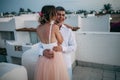 Happy newlyweds hug on roof of house during the honeymoon Royalty Free Stock Photo