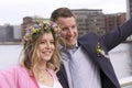 Happy newlyweds just married wedding couple couple smiling - beautiful girl with bouquet of flowers and floral wreath in her hair Royalty Free Stock Photo