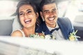 Happy newlyweds laugh together in the car after their wedding day is over Royalty Free Stock Photo