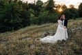 Happy newlyweds are sitting on a rock in the nature Royalty Free Stock Photo
