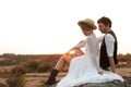 Happy newlyweds sitting on rock Royalty Free Stock Photo