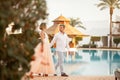 Happy newlyweds walk on the villa next to the swimmimg pool during the honeymoon Royalty Free Stock Photo