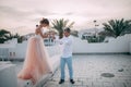 Happy newlyweds walk on roof of house during the honeymoon in the evening Royalty Free Stock Photo