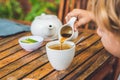 Happy nice boy pours honey into the tea in summer green garden. Portrait. outdoor Royalty Free Stock Photo
