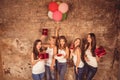 Happy nice-looking girls holding birthday cake, balloons and presents