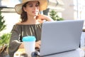 Happy nice woman working on laptop in street cafe Royalty Free Stock Photo