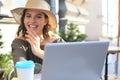 Happy nice woman working on laptop in street cafe Royalty Free Stock Photo