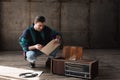 happy nostalgic young man in vintage windcheater with vinyl