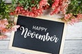 Happy November text on blackboard with flower bouquet decoration