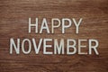 Happy November text message on wooden background