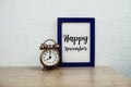 Happy November typography text and alarm clock on wooden table and white wall background