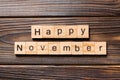 Happy november word written on wood block. Happy november text on table, concept Royalty Free Stock Photo