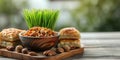 Happy Nowruz holiday background. Green grass semeni and baklava with nuts. Nowruz background with holiday symbols