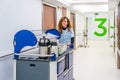 Nurse carrying coffee with a trolley along hospital