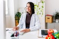 Happy nutritionist doctor working on desktop computer at clinic office Royalty Free Stock Photo