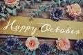 Happy October alphabet letter and flower decorate on wooden background