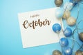 Happy October typography text with LED cotton ball on blue background