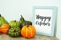 Happy October text with pumpkin decoration on wooden table