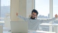 Happy office employee Arabian Indian man tired muslim businessman entrepreneur relax take break after computer laptop Royalty Free Stock Photo