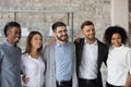 Happy young coworkers posing for group photo in office