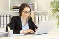 Happy office worker with eyeglasses working online