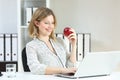 Happy office worker working holding an apple