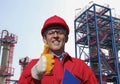 Oil and Gas Refinery Worker in Red Hardhat and Coveralls Looking At Camera Royalty Free Stock Photo