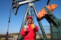 Happy Oil Worker With Money and Pump Jack Royalty Free Stock Photo