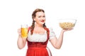 happy oktoberfest waitress in traditional bavarian dress holding bowl of popcorn and mug of light beer Royalty Free Stock Photo