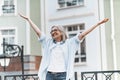 Happy old age, featuring senior lady raising her hands up to skies with beaming smile on balcony overlooking picturesque Royalty Free Stock Photo