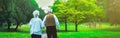 Happy old age senior couple love story. Peole is walking in the green park. Grandmother and grandfather holding hands. Elderly