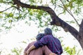 Happy old asian couple under tree Old man and Old woman or Grandfather and grandmother embracing each other with love Elderly